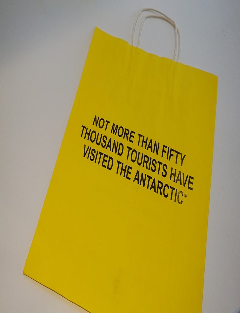 Item #46691 NOT MORE THAN FIFTY THOUSAND TOURISTS HAVE VISITED THE ANTARCTIC. Art Metropole Paper Shopping Bag. Maurizio Nannucci.